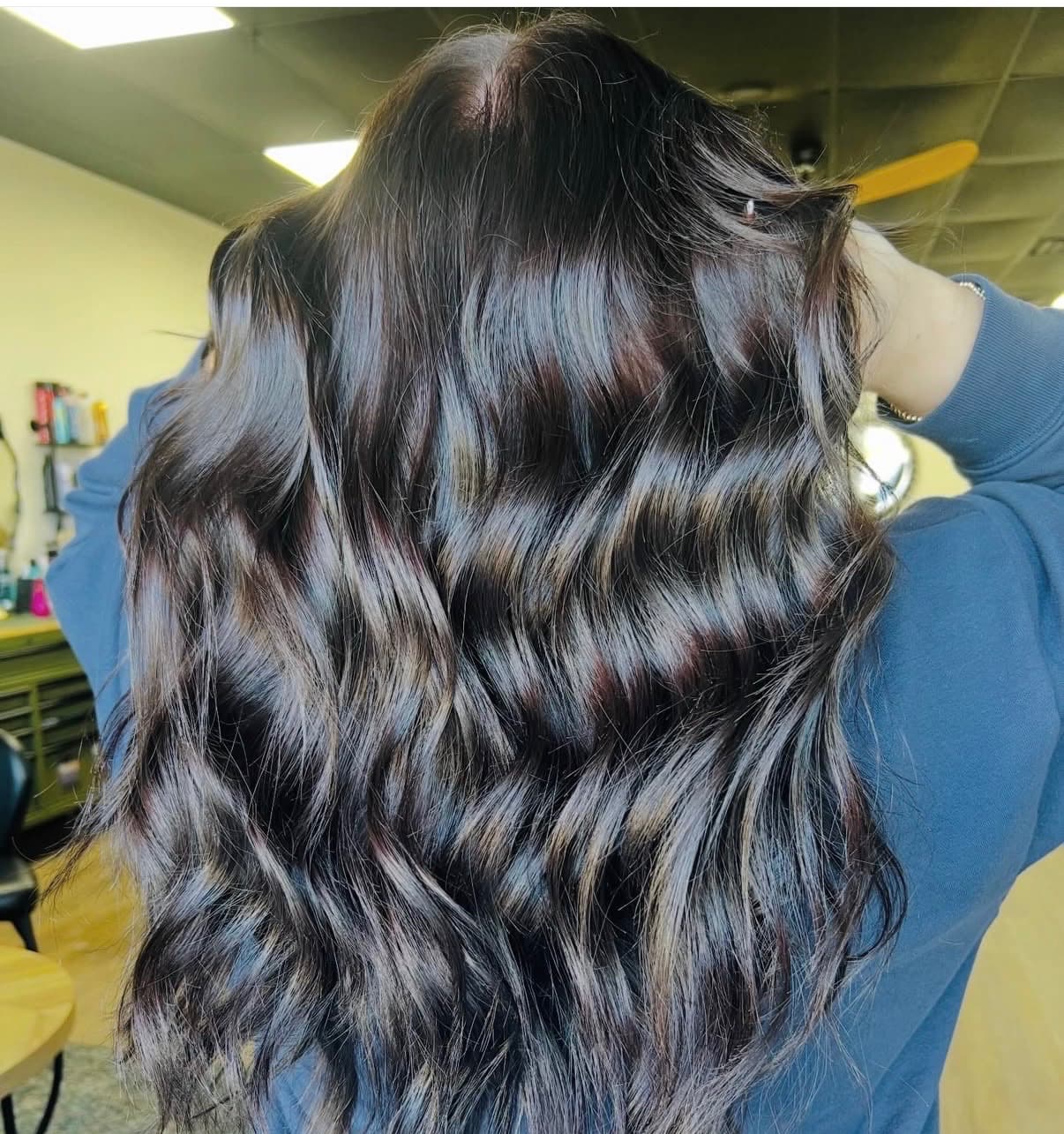 Dark brunette hair with silver ribbon highlights styled in waves at The Hair Collective Oklahoma City
